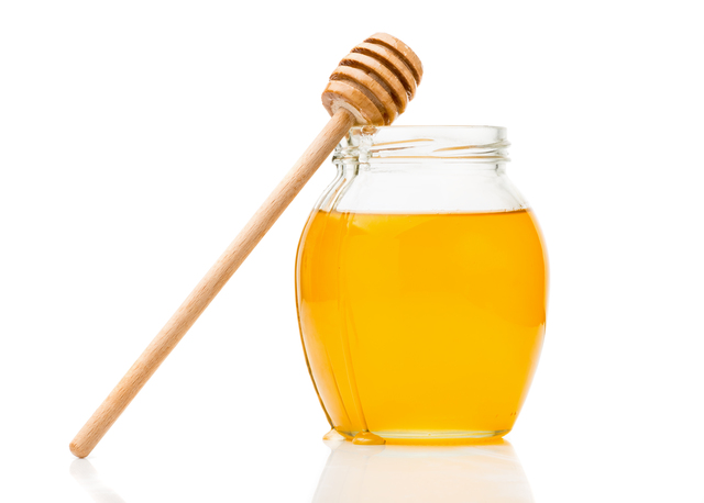 Natural honey in a glass jar