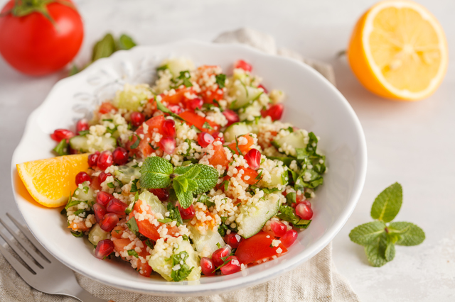 Tabbouleh salad with tomato, cucumber, couscous, mint and pomegr