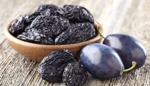 Prunes on a wooden background