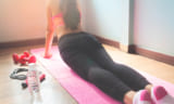 Young woman in pink sport bra doing yoga, Healthy lifestyle