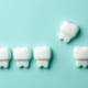 Healthy white teeth and removing yellow tooth with caries agains