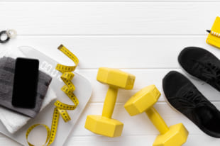 Flat lay top view sport equipments, sneakers and smartphone on wooden background