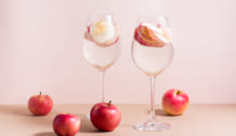 Refreshing cocktail of apple pieces and mineral water in wine gl