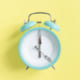 intermittent fasting concept - blue alarm clock, top view